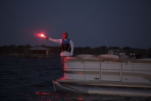 Using a handheld flare at dusk aboard a boat 16-21 feet.