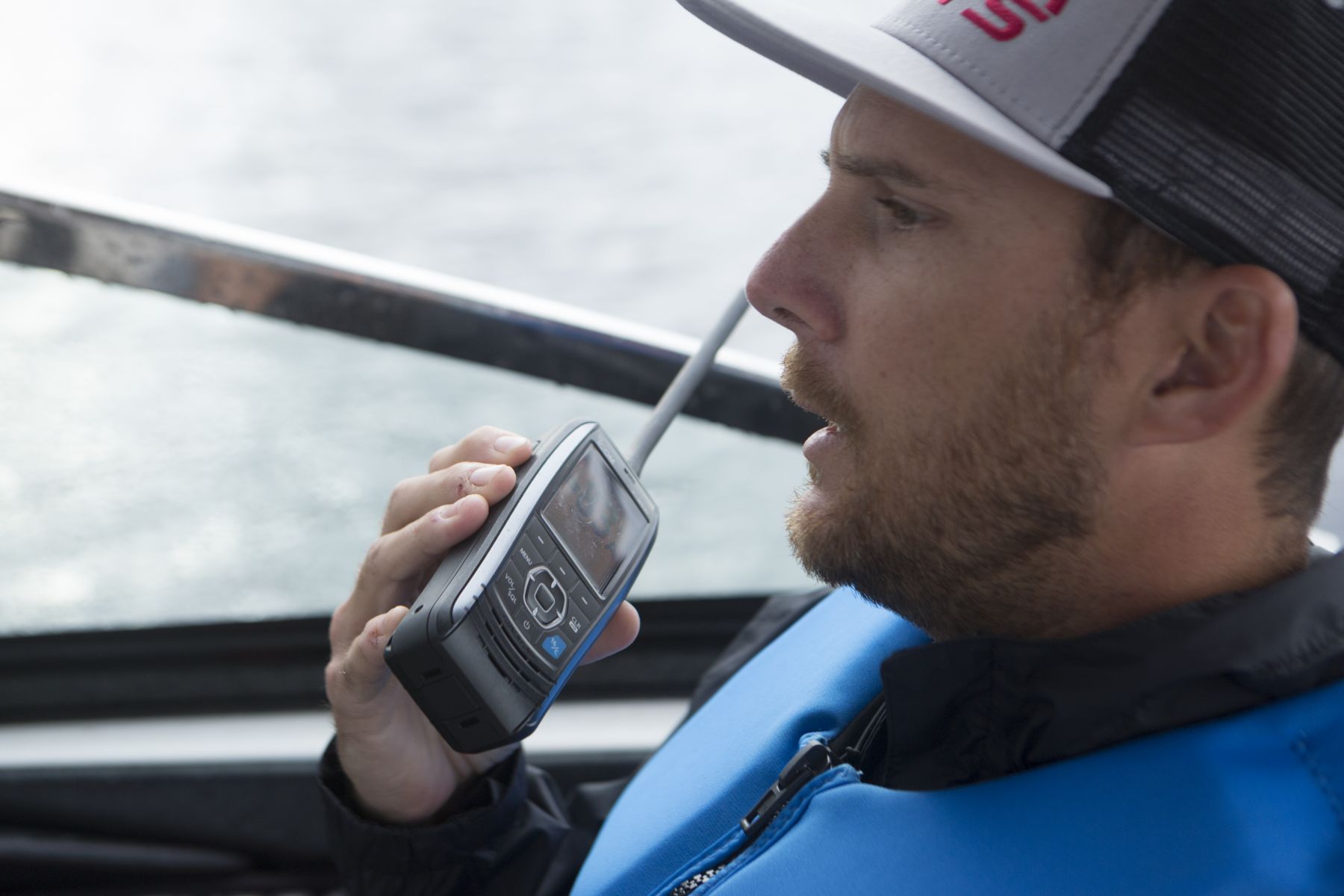 Using a handheld VHF-DSC marine band radio set to channel 16.