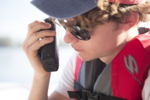 Using a handheld VHF-DSC marine band radio set to channel 16.