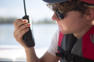 Using a handheld VHF-DSC marine band radio set to channel 16.