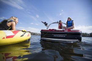 Kids having a fun afternoon on the water in properly fitting life jackets.