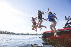 Kids having fun on the water in properly fitting life jackets.