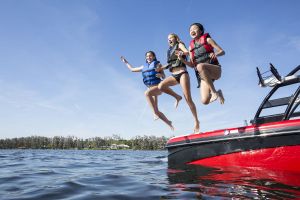 Kids having fun on the water in properly fitting life jackets.