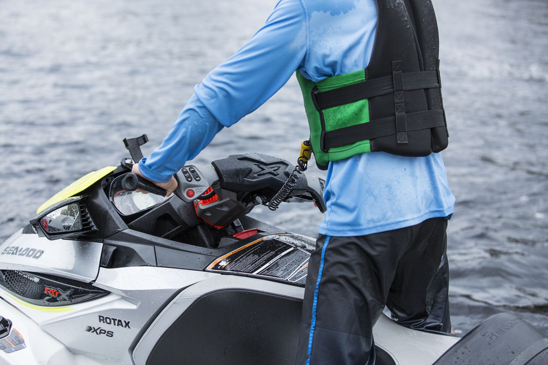 Using a safety lanyard kill switch on a personal watercraft while wearing a properly fitting life jacket.