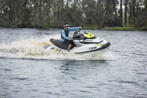 Riding a personal watercraft while wearing a properly fitting life jacket.