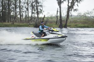Riding a personal watercraft while wearing a properly fitting life jacket.