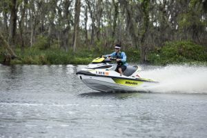 Riding a personal watercraft while wearing a properly fitting life jacket.