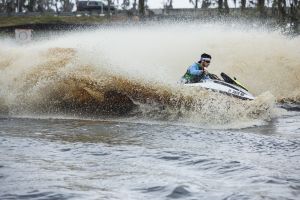 Riding a personal watercraft while wearing a properly fitting life jacket.