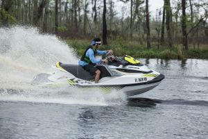 Riding a personal watercraft while wearing a properly fitting life jacket.