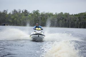 Riding a personal watercraft while wearing a properly fitting life jacket.