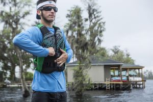 Putting a life jacket on before operating a personal watercraft.