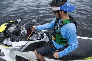 Using a safety lanyard kill switch on a personal watercraft while wearing a properly fitting life jacket.