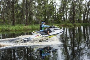 Riding a personal watercraft while wearing a properly fitting life jacket.