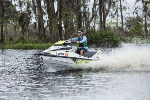 Riding a personal watercraft while wearing a properly fitting life jacket.