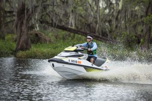 Riding a personal watercraft while wearing a properly fitting life jacket.