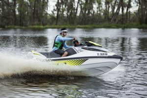 Riding a personal watercraft while wearing a properly fitting life jacket.