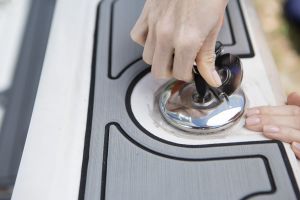 Opening a locked gas cap on a boat.