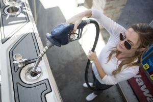 Inserting the nozzle in the fuel neck for refueling a boat at a land pump.