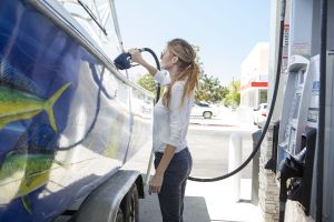 Refueling a boat at a land pump.