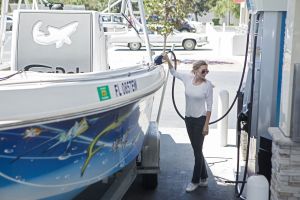 Refueling a boat at a land pump.