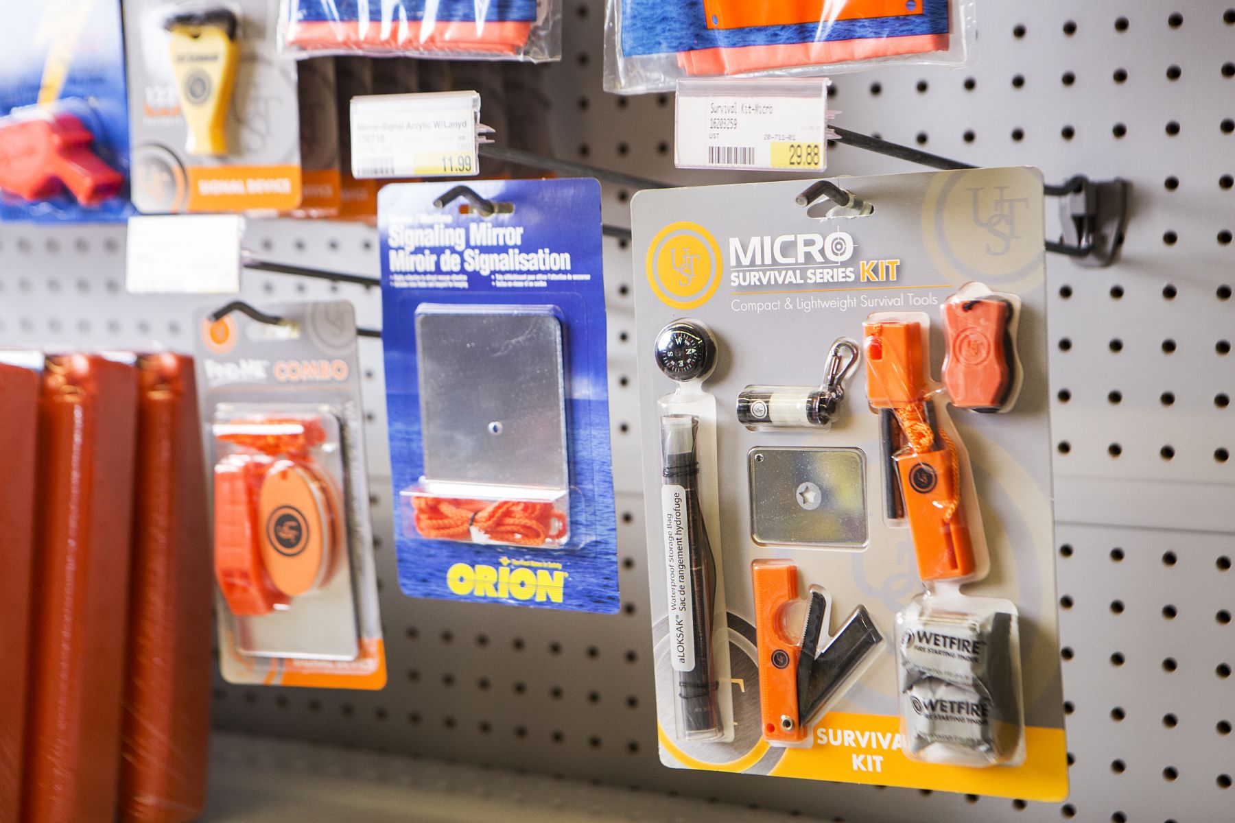 Signaling mirrors and other safety equipment on the shelves at a retail outlet.