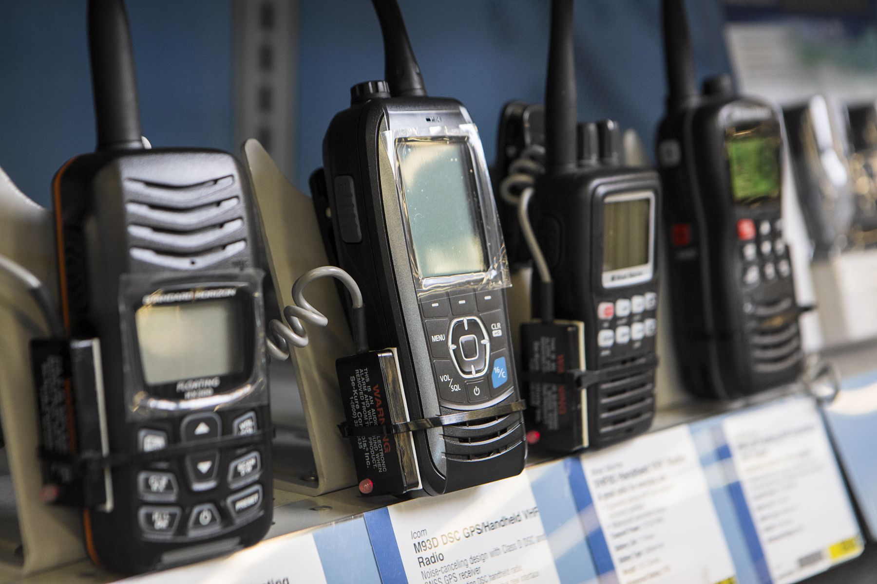 Handheld VHF radios on display at a retail outlet.