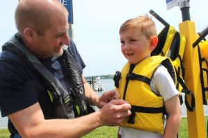 STF-Dad-put-life-jacket-on-kid